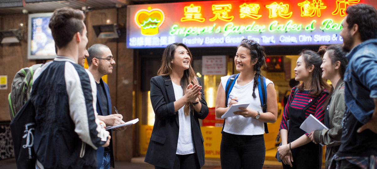 A group of students walking down a colourful laneway